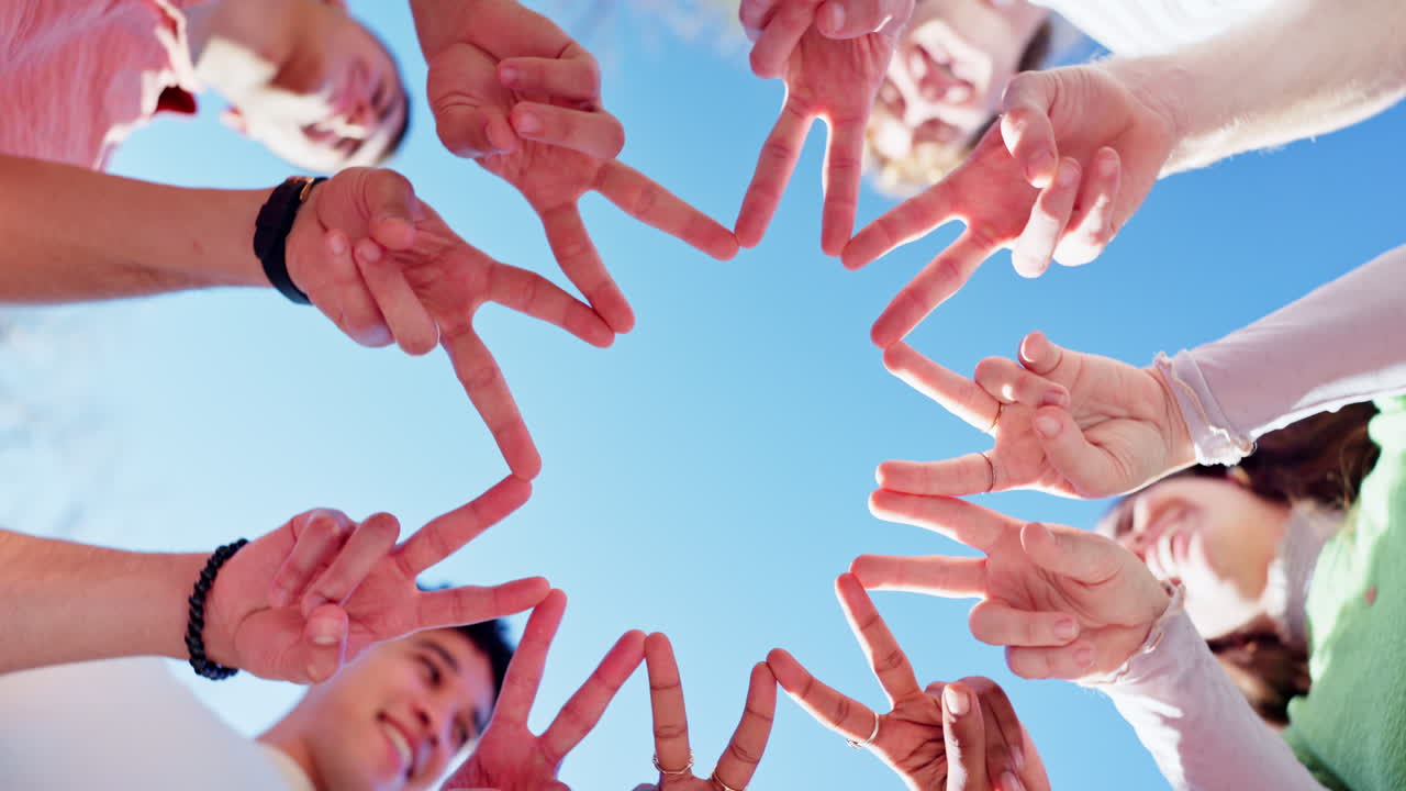 Team celebrating success with peace signs