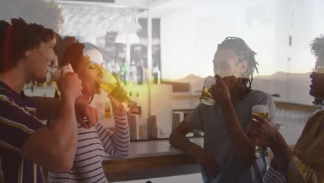 animation of glass with beer over diverse friends having drink in bar