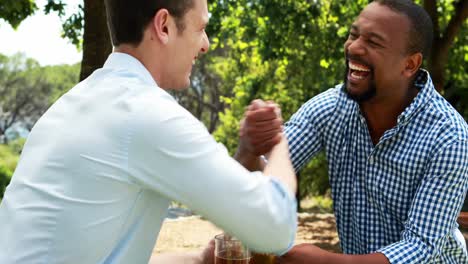 male friends toasting beer mugs in outdoor restaurant 4k