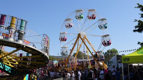 crowds enjoy rides at a vibrant fair