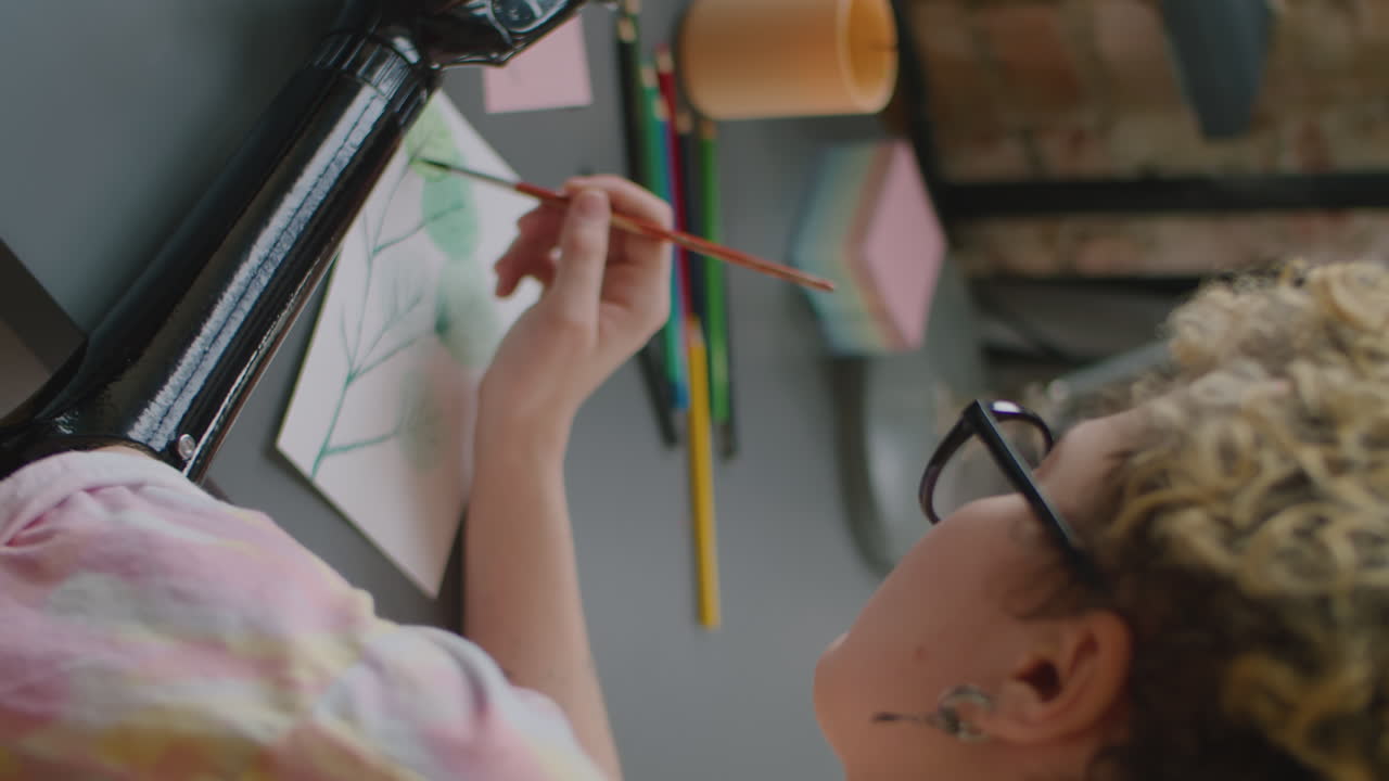 Girl with Prosthetic Arm Painting with Watercolors