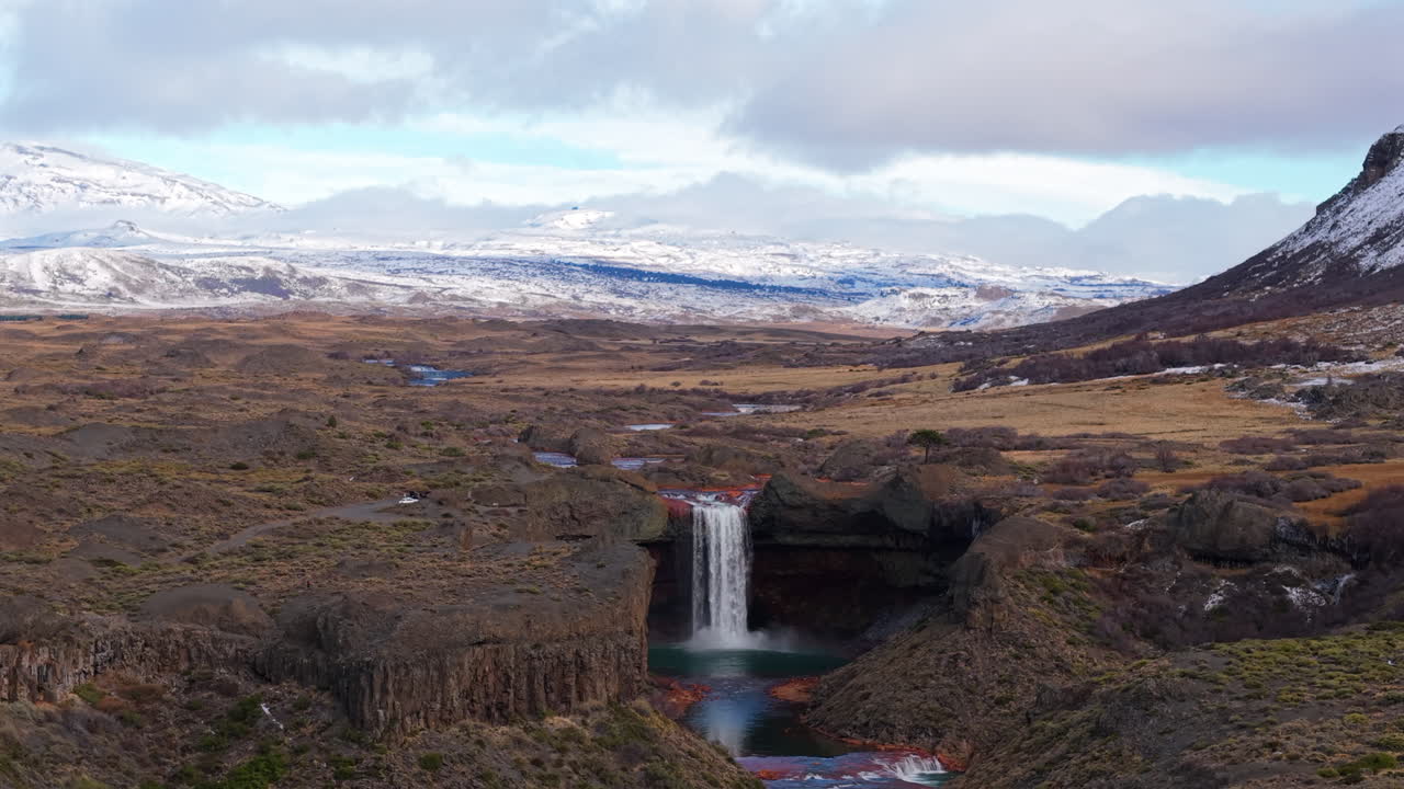 Agrio Waterfall aka Salto Del Agrio cascading into a river surrounded by rugged rocky terrain, Caviahue, Neuquén, Argentina