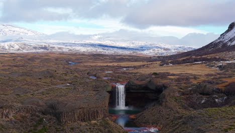 agrio waterfall aka salto del agrio cascading into a river surrounded by rugged rocky terrain, caviahue, neuquén, argentina