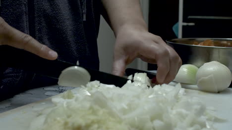 close up view of female hands white onions on cutting board