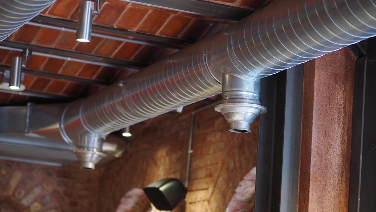 Industrial Metal Ventilation Ducting in a Brick Ceiling Interior
