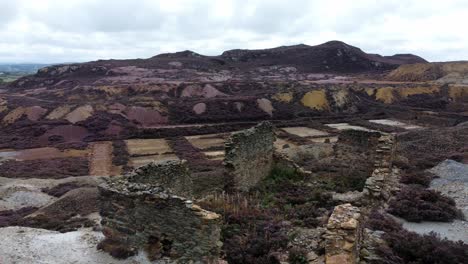 Parys-mountain-rocky-copper-mining-stone-ruin-excavation-quarry-aerial-rising-view-Anglesey-mine-Wales-UK