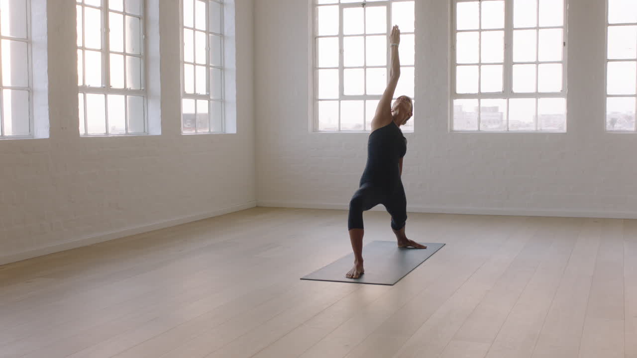 beautiful yoga woman practicing reverse warrior pose enjoying fitness lifestyle exercising in studio stretching flexible body training early morning meditation on exercise mat