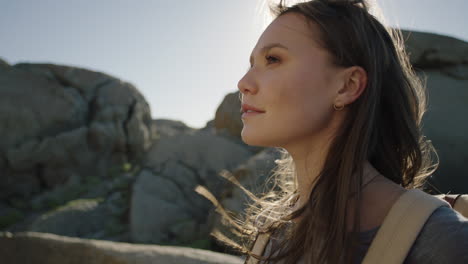 close up independent young tourist woman enjoying beautiful ocean seaside smiling happy exploring vacation adventure lifestyle on windy summer day