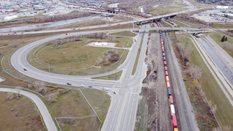 in calgary's industrial area, a long train waits on the rails