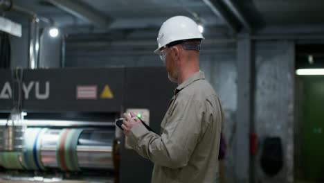 factory worker inspecting machinery