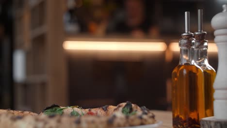 pizza and condiments at a restaurant