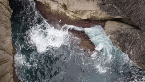 ocean waves crashing against rocky coastline