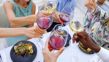 Group-of-friends-toasting-glasses-of-wine-