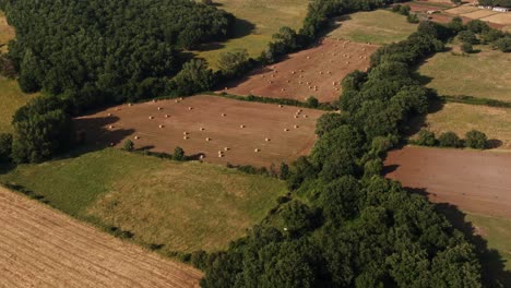 aerial view of hay bales in plowed field