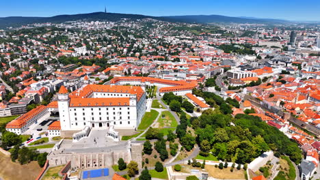 stunning view on the bratislava castle from drone. green gardens on the territory. city panorama at backdrop