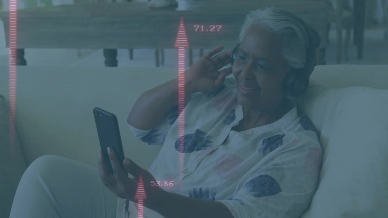 Senior woman tapping phone screen and adjusting headset while monitoring red health metrics