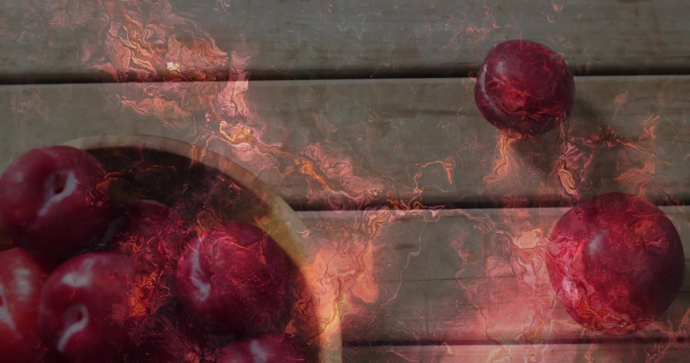 Fiery animation overlay on red apples resting on wooden surface