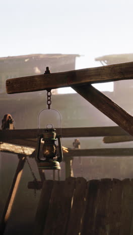 closeup of a vintage lantern hanging from a wooden beam