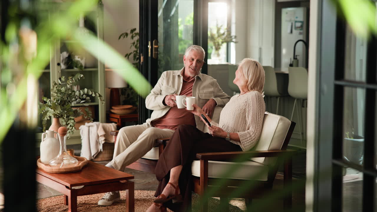 Happy Senior Couple Relaxing and Talking Over Coffee at Home