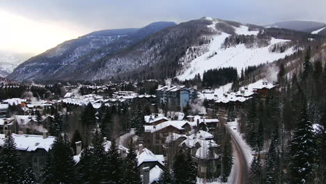 Aerial-Cinematic-Drone-Vail-Village-Vail-ski-resort-Golden-Peak-early-morning-mid-winter-sunrise-of-ski-trails-and-gondola-scenic-mountain-landscape-of-Colorado-up-movement