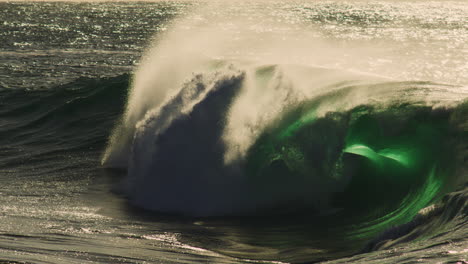 green wave curls left at golden hour, glowing edges and textured ripple across surface