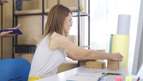 entrepreneurial couple in office of small online clothing store.