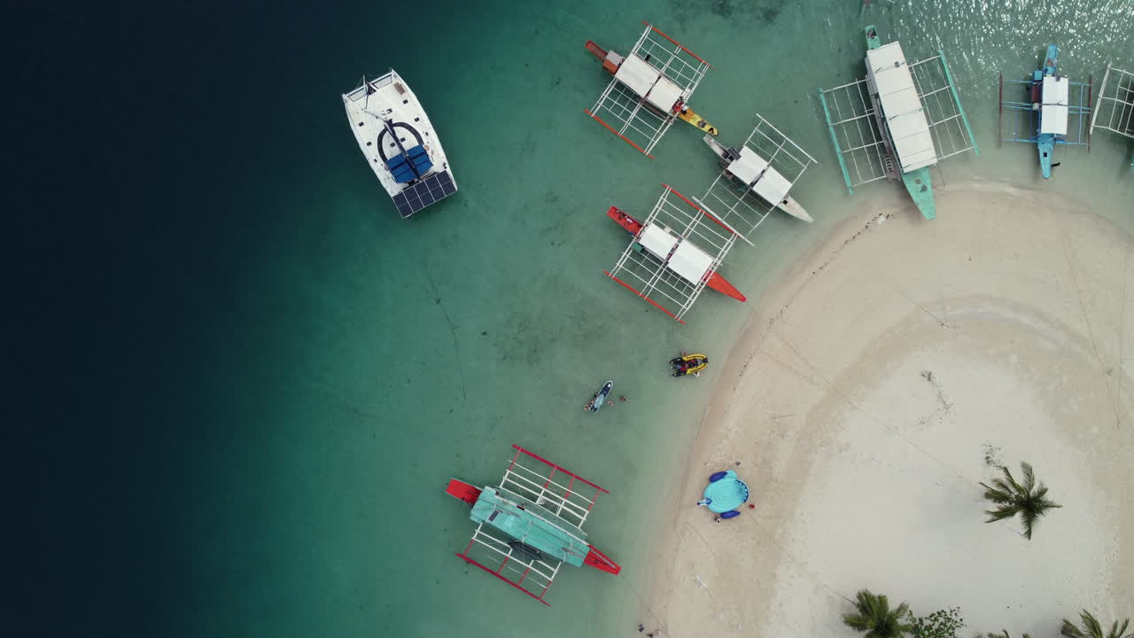 group of boats parked at the beach