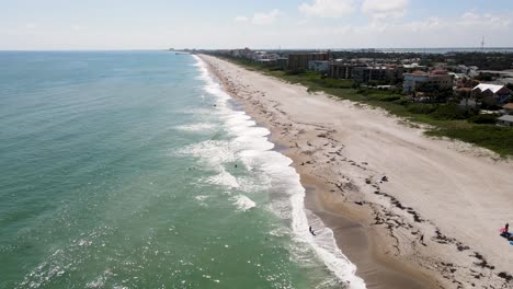 local surf spot on cocoa beach in florida on atlantic coast, aerial