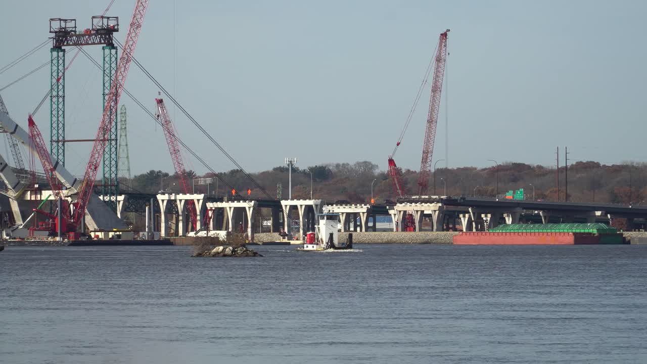 Pan of Idled Construction of I-74 Bridge Over the Mississippi River at Quad Cities; delays caused by monetary contract disputes, potential design errors, labor shortages and poor weather