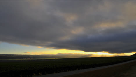 time lapse of cloudy sunset over a vineyard