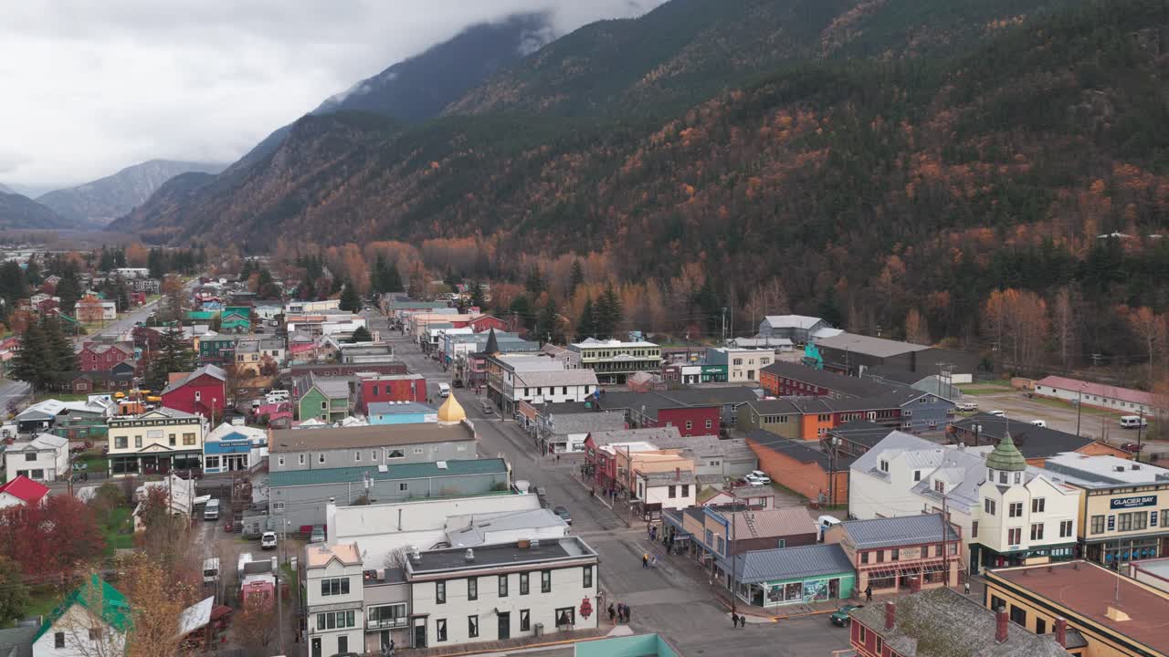 Descending and panning aerial shot of historic Skagway, Alaska in the fall season. 4K