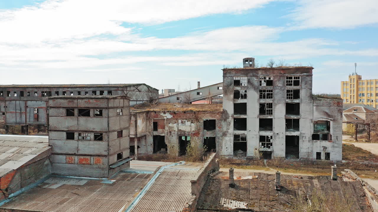 Aerial view of an old factory ruin and broken windows. Old industrial building for demolition.