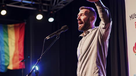 man giving a speech on stage at an event