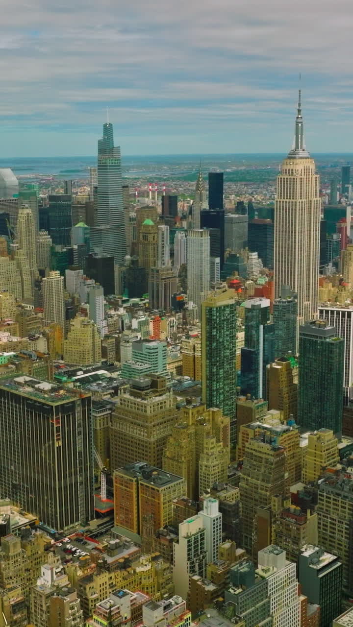 Densely built up city with skyscrapers and usual blocks of flats. Huge New York panorama at the blue sky background. Vertical video