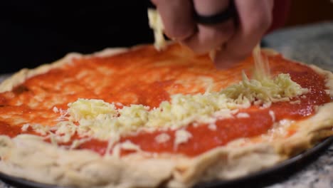 chef putting mozzarella chef on a pizza in slow motion