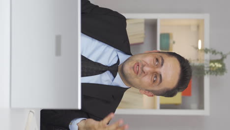 Vertical-video-of-Home-office-worker-man-happy-and-cheerful.