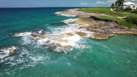 sea waves splashing on the shore in a scenic resort in bahamas - aerial drone shot