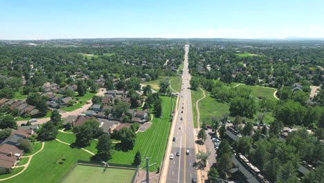 Aerial-Drone-video-of-Cars-driving-through-a-suburb-or-neighborhood-in-Denver,-Colorado,-USA