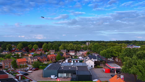 residential area surrounded by gorgeous green forests. amazing blue sky with beautiful clouds is over the town