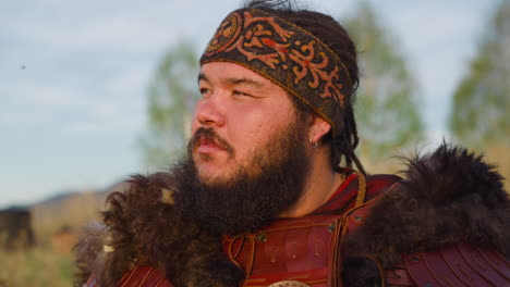 positive man with patterned headband looks in distance