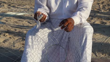 close up of hands making lobster trap