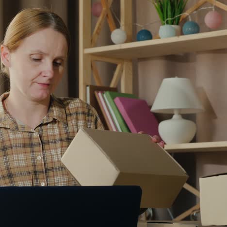 a woman works at home looks through parcels ready to be shipped