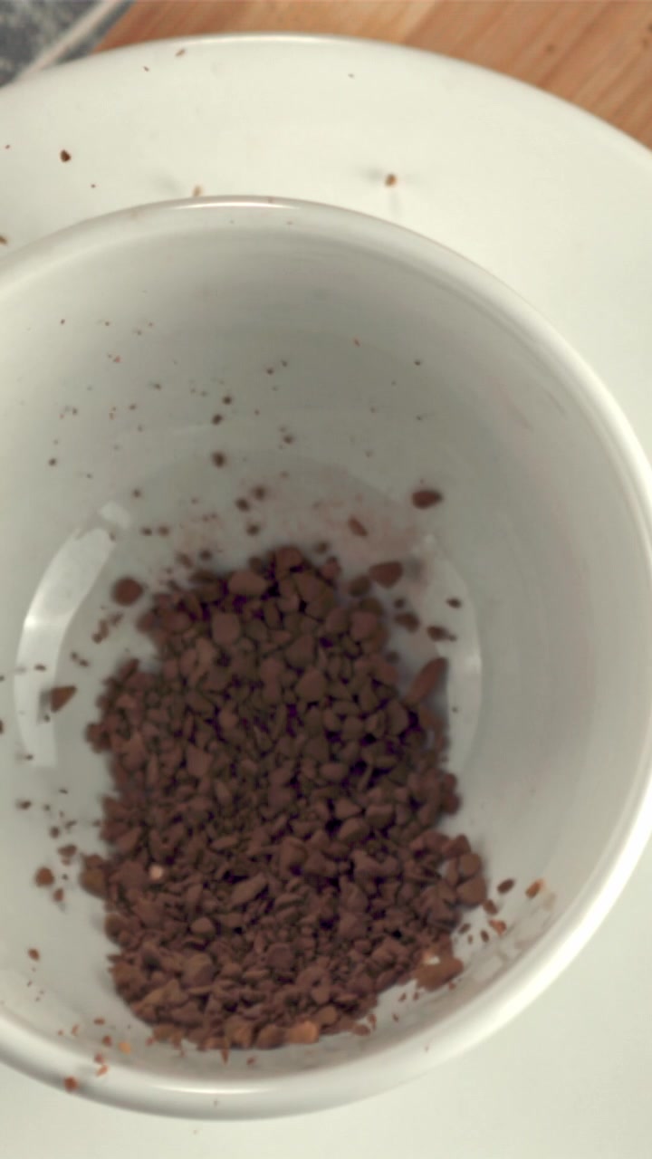 Grânulos de Café Instantâneo Caindo em uma Xícara Branca