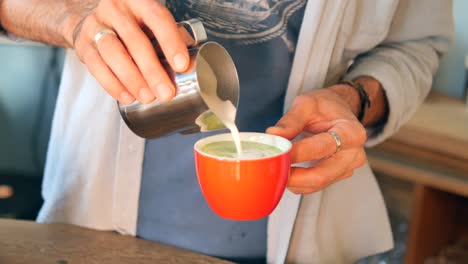 barista making a matcha latte