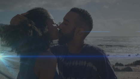 couple sharing kiss on beach in health campaign, with animated sun lens flare and wave icons