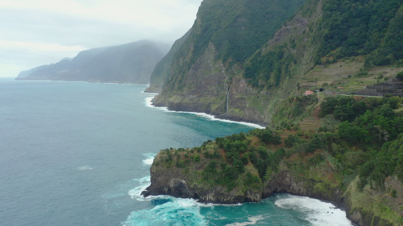 Coast line Miradouro do V&eacute;u da Noiva waterfall madeira drone shot cloudy mountains with waves panorama Sky ocean, beach