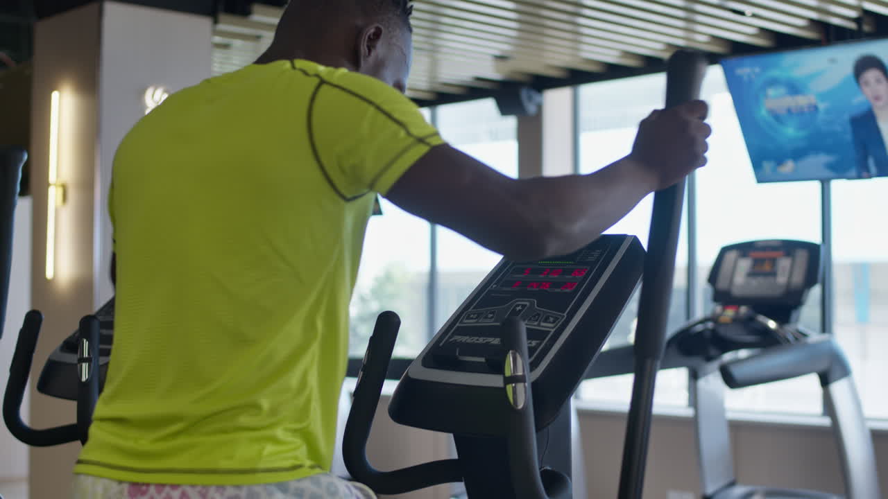 Person Working Out on a Cross Trainer in a Gym