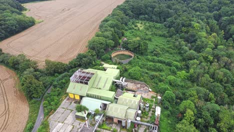 Aerial-reverse-birdseye-view-over-the-now-abandoned-Thruxted-Mill-near-Canterbury-Kent---A-former-animal-processing-plant-used-for-rendering-cattle-during-the-height-of-the-BSE-Mad-Cow-Disease-Crisis