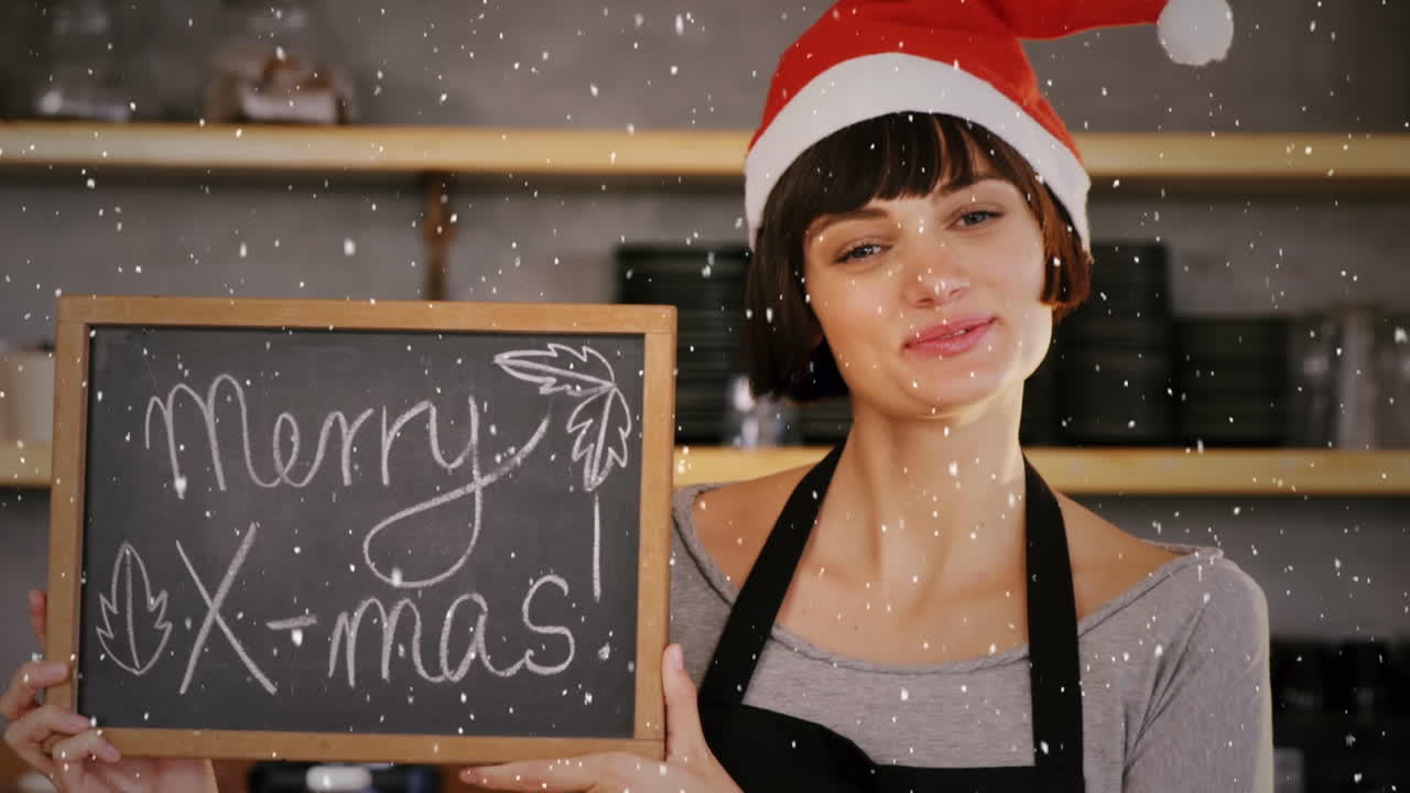 산타 모자에서 카페 가게 소유자 위에 눈이 내리는 비디오 구성 인사와 함께 보드