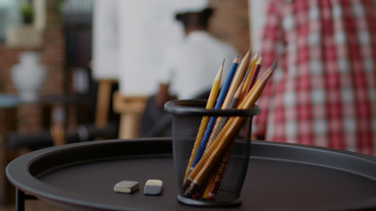 Colorful pencils and erasers on table in art class studio